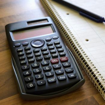 Calculator being used next to a notebook