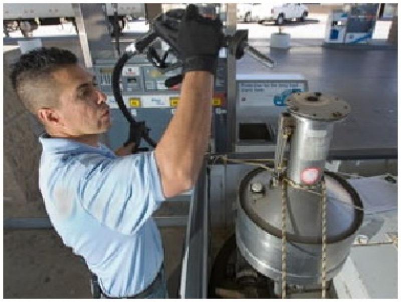 Gas pump inspection, Person testing a gas pump with equipment